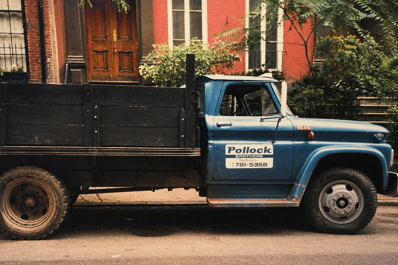 Blue vintage truck parked on city street.